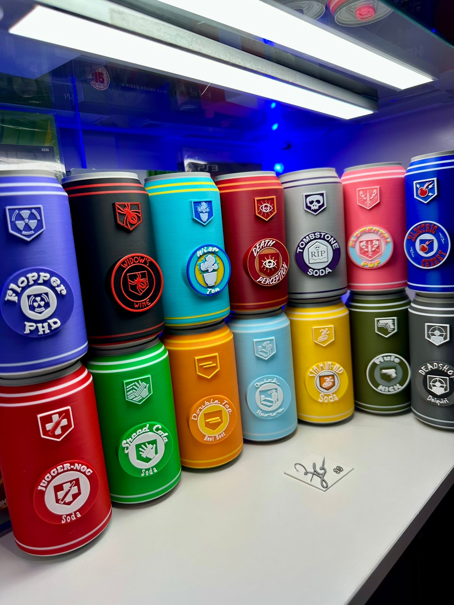 Colorful cans with various designs arranged on a white surface.