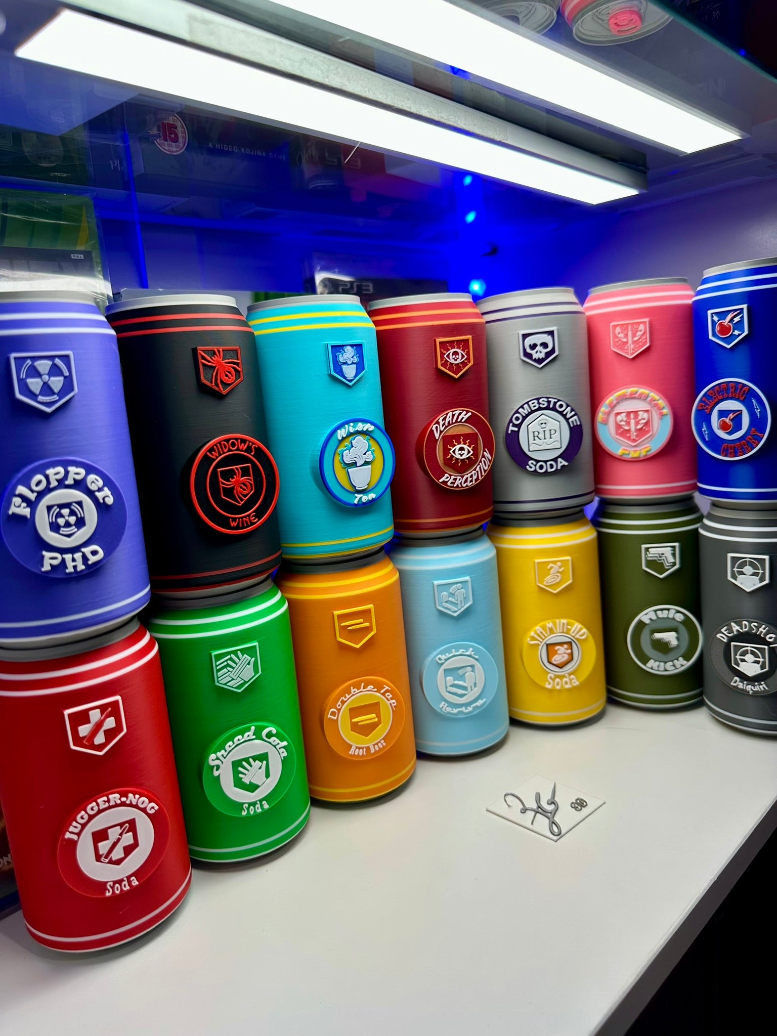 Colorful cans with various designs arranged on a white surface.